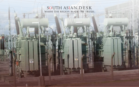 Three large electrical transformers in an outdoor substation, surrounded by a fence and power lines under a clear blue sky.