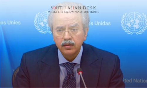 A man in a suit and tie speaking at a podium with a United Nations backdrop, featuring the UN logo and text in multiple languages.