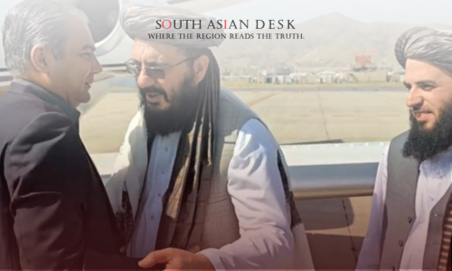 Three men engaged in conversation near a private airplane on a tarmac, with two wearing traditional Afghan attire and turbans, and one in a dark suit, with mountains visible in the background.