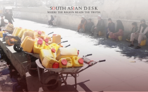 Several wheelbarrows filled with yellow water containers lined up along a sidewalk, with people sitting against a wall in the background.