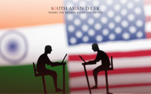 Silhouettes of two people working at desks, set against the background of the Indian and American flags.