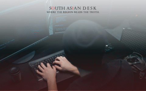 A dark-themed workspace with a computer monitor, keyboard, and a coffee cup, suggesting a late-night coding or hacking session.