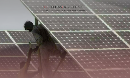 Two workers in light-colored clothing install or maintain solar panels on a large array, with one standing on a ladder and the other assisting below, against a clear sky.