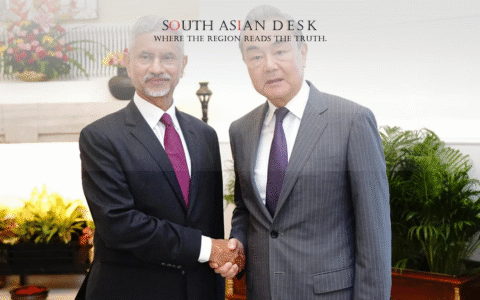 Indian Foreign Minister in a black suit shaking hands with the Chinese Minister wearing a Grey Suit during India and China Talks