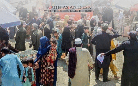 Afghan migrants with belongings at a border crossing amid forced deportations.
