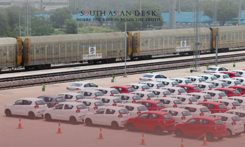 Various Red and White Mini Cars are parked in a Large Ground after GST reforms in India