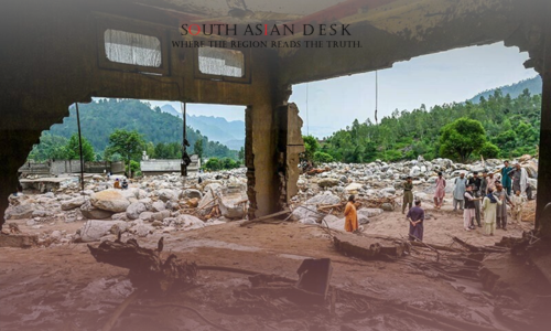 An inside view of the outside from a devastated building, while various men stand outside over the building's debris after flash floods