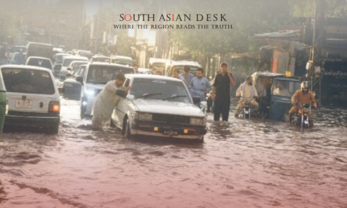 A man navigates a flooded street in Peshawar, Pakistan, after heavy monsoon rains on August 30, 2025, linked to KP flash flood deaths.