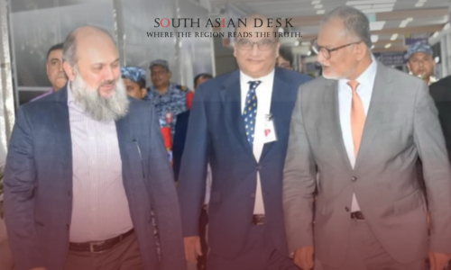 Three government officials walking through a hallway during the Bangladesh Visit