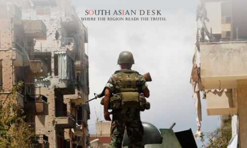 A man in uniform standing, depicting syrian fighters