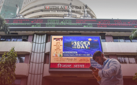 A man looking on his phone in front of Indian Stock Exchange after Sensex Crash