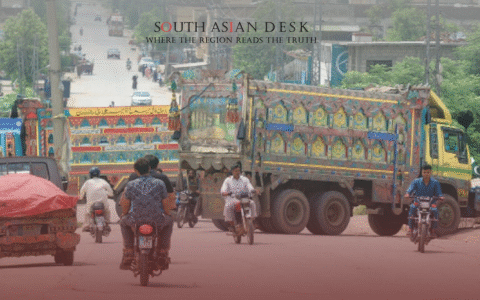 Various colorful trucks blocking a Pakistani road and bike after Protest call