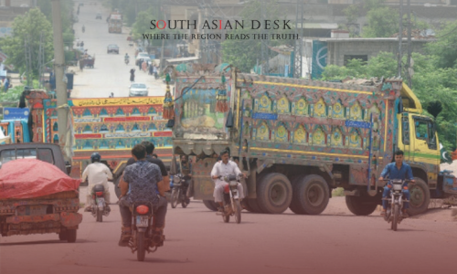 Various colorful trucks blocking a Pakistani road and bike after Protest call