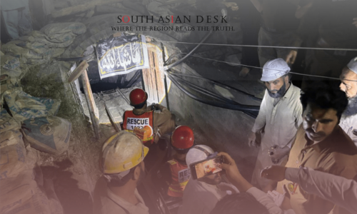 Rescue team members in red helmets and vests working inside Swat emerald mine