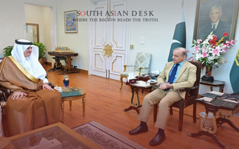 Saudi Crown Prince sitting in a chair talking to shehbaz shareef