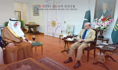 Saudi Crown Prince sitting in a chair talking to shehbaz shareef