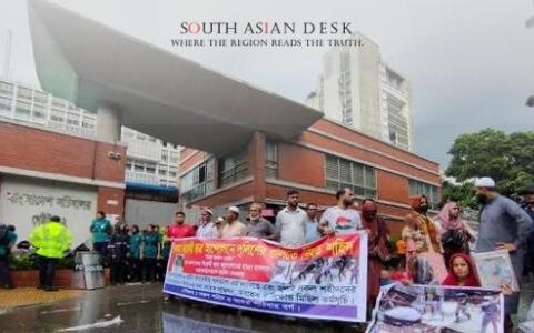 Bangladeshi Protesters holding banners and photographs demonstrate outside a government building, demanding the resignation of Asif Nazrul.