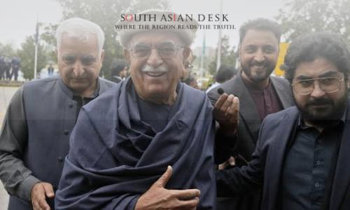Imran Khan Names Mahmood Achakzai as Opposition Leader, Signals Robust Political Strategy 1 A group of men, including Mahmood Khan Achakzai, smiles and wears a shawl as they walk outdoors.