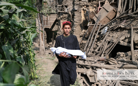 Afghanistan Earthquake Aid Crisis as a young boy carrying a dead body on his own