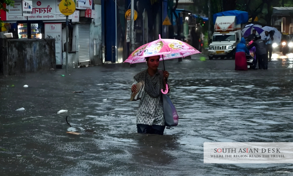 The impact of India rains 2025 can be seen in the picture as the girl half submerged in the water