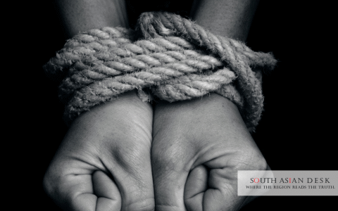 A tied hands of a person depicting US human trafficking watchlist
