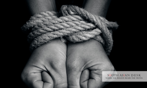 A tied hands of a person depicting US human trafficking watchlist