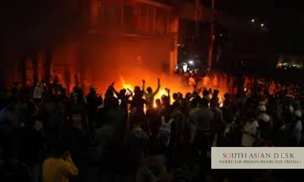 Crowd protesting amidst flames and smoke in Bangladesh Violence